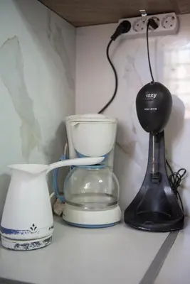 a shelf with a blender and other appliances on it at Minimal Flat in Historic Kerameikos by ΜΡS in Athens