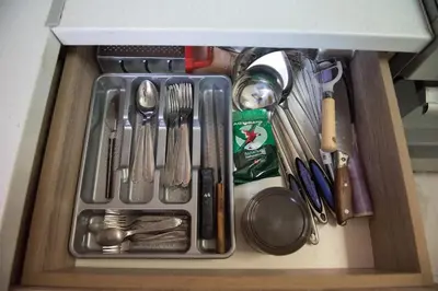a drawer filled with utensils in a cabinet at Minimal Flat in Historic Kerameikos by ΜΡS in Athens