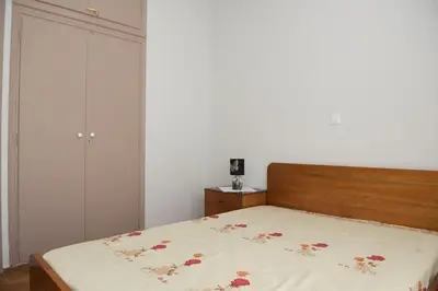 a bedroom with a bed with a floral bedspread at Minimal Flat in Historic Kerameikos by ΜΡS in Athens