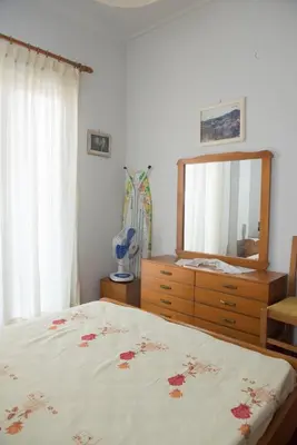 a bedroom with a bed and a dresser and a mirror at Minimal Flat in Historic Kerameikos by ΜΡS in Athens