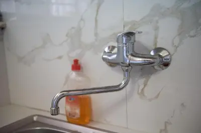 a sink with a faucet and a bottle of soap at Minimal Flat in Historic Kerameikos by ΜΡS in Athens