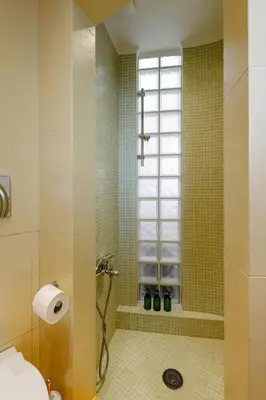 a bathroom with a shower and a window at Sky Suite with View & Jacuzzi in Athens