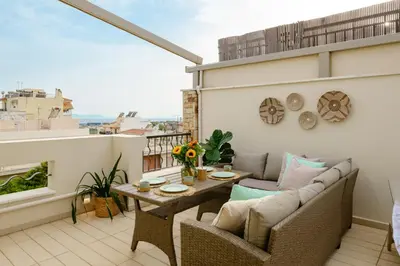 a balcony with a couch and a table on a building at Sky Suite with View & Jacuzzi in Athens
