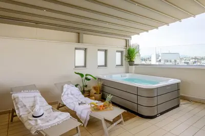 a large bathroom with a hot tub on a balcony at Sky Suite with View & Jacuzzi in Athens