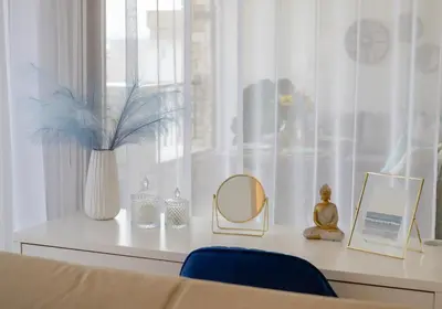 a table with a mirror and a vase on a window at Sky Suite with View & Jacuzzi in Athens