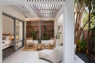 a room with a bed and a table and chairs at 3BD 2 Floor Maisonette with Pool in Athens