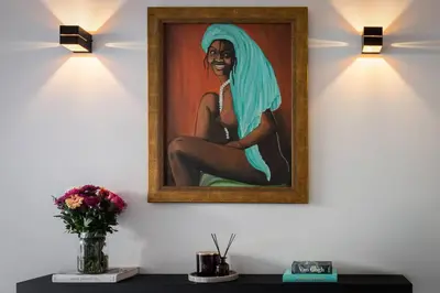 a painting of a woman sitting on a wall with lights at 3BD 2 Floor Maisonette with Pool in Athens
