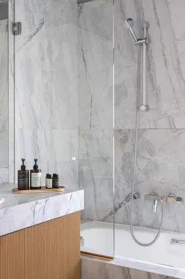 a bathroom with a shower and a bath tub at 3BD 2 Floor Maisonette with Pool in Athens