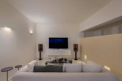 a living room with a couch and a flat screen tv at 3BD 2 Floor Maisonette with Pool in Athens