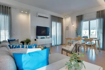 a living room with a couch and a dining room at Kerameikos Acropolis view in Athens
