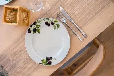 a plate with flowers on it sitting on a table at Kerameikos Acropolis view in Athens
