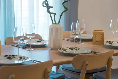a wooden table with wine glasses and a vase at Kerameikos Acropolis view in Athens