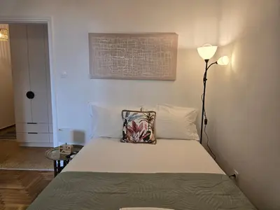 a bedroom with a bed with a pillow and a lamp at Down town in Athens