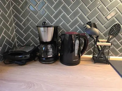 a black coffee maker and a blender on a counter at Down town in Athens