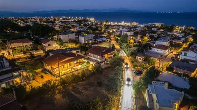 an aerial view of a city at night at NoamansHouse SeaView near Airport in Artemida