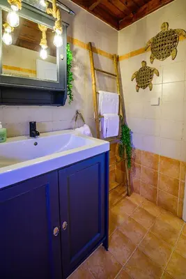 a bathroom with a blue sink and a shower at NoamansHouse SeaView near Airport in Artemida
