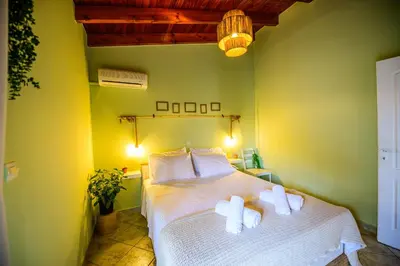 a bedroom with a bed with two white pillows at NoamansHouse SeaView near Airport in Artemida