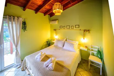 a bedroom with a bed with towels on it at NoamansHouse SeaView near Airport in Artemida