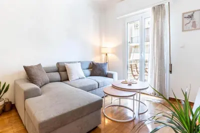 a living room with a couch and a table at The Homely Hideaway in Athens