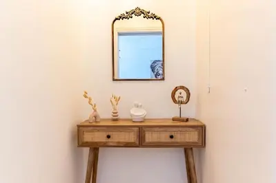 a dressing table with a mirror on a wall at The Homely Hideaway in Athens