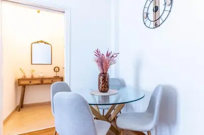 a dining room with a glass table and chairs at The Homely Hideaway in Athens