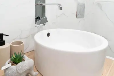a bathroom with a white tub and a sink at The Homely Hideaway in Athens