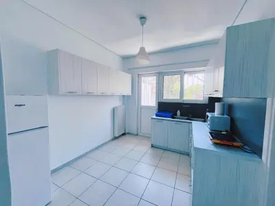 a kitchen with blue cabinets and a white refrigerator at City Center 2-Bedroom Sun home in Athens