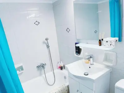 a white bathroom with a sink and a shower at City Center 2-Bedroom Sun home in Athens
