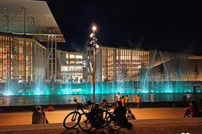 a building with a fountain in front of it at night at City Center 2-Bedroom Sun home in Athens