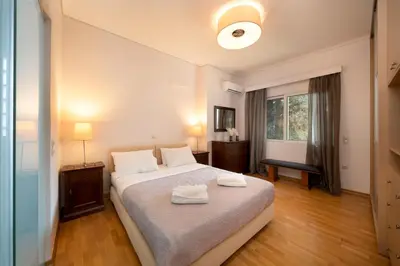 a bedroom with a bed with two towels on it at Casa Tierra Near ATH Airport in Markopoulo
