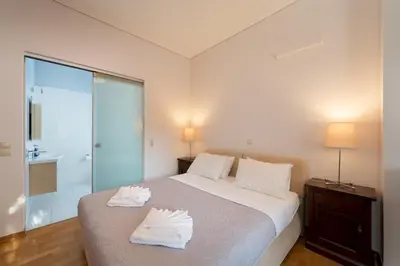 a bedroom with a bed with two towels on it at Casa Tierra Near ATH Airport in Markopoulo