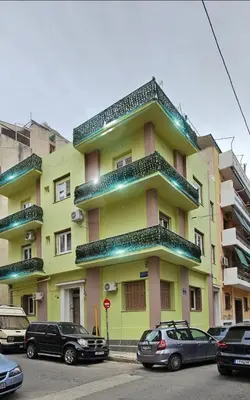 a yellow building with cars parked in front of it at Knezevic Resort 12 in Athens