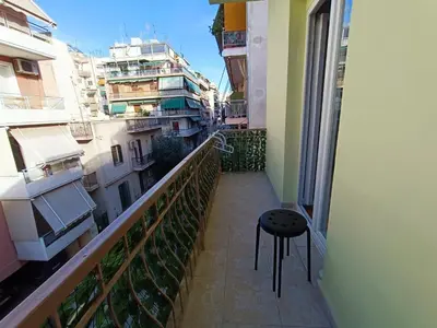 a stool sitting on the balcony of a building at Knezevic Resort 12 in Athens