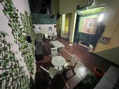 a room with a table and chairs and plants at Knezevic Resort 12 in Athens