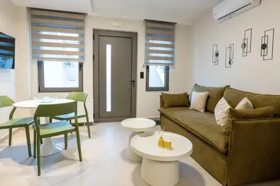 a living room with a couch and a table at ALMARLIVING Stylish 2BR Apartment in Ilioupolis in Athens
