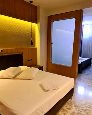 a bedroom with a large bed with a large window at The George in Piraeus