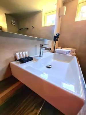 a bathroom with a white sink and a mirror at The George in Piraeus