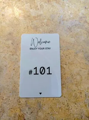 a white sign on a counter with the words i welcome enjoy your stay at The George in Piraeus