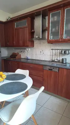 a kitchen with a table and chairs in a kitchen at John & Mary's House Kalivia Near Sea & Athens Airport in Kalívia Thorikoú