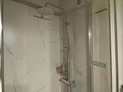 a shower with a glass door in a bathroom at John & Mary's House Kalivia Near Sea & Athens Airport in Kalívia Thorikoú