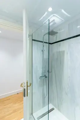 a shower with a glass door in a bathroom at Athens Plaka Acropolis Suites in Athens