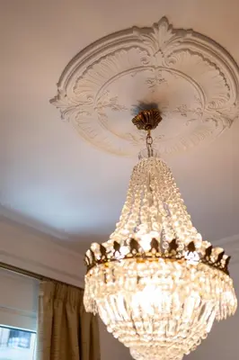 a large white chandelier hanging from a ceiling at Athens Plaka Acropolis Suites in Athens