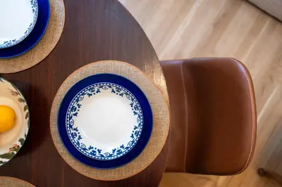 a table with plates and hats on top of it at Athens Plaka Acropolis Suites in Athens