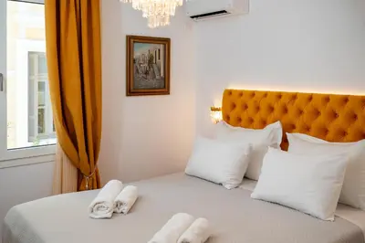 a bedroom with a bed with towels on it at Athens Plaka Acropolis Suites in Athens