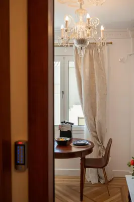 a room with a table and a chandelier at Athens Plaka Acropolis Suites in Athens