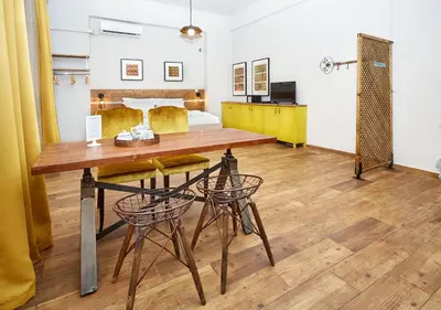 a dining room with a table and two chairs at Aris Athens Suites in Athens