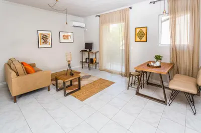 a living room with a couch and a table at Aris Athens Suites in Athens