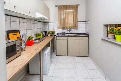 a large kitchen with wooden counter tops in a room at Aris Athens Suites in Athens