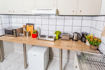 a kitchen counter with a microwave and appliances on it at Aris Athens Suites in Athens