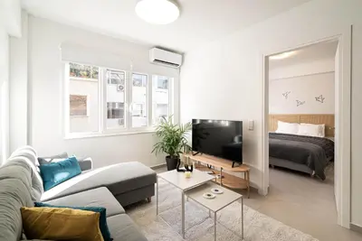 a living room with a couch and a bed at Athens Urban Apartment in Athens